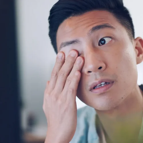 Asian businessman, tired and hand on face in communication office, headache and marketing company. .